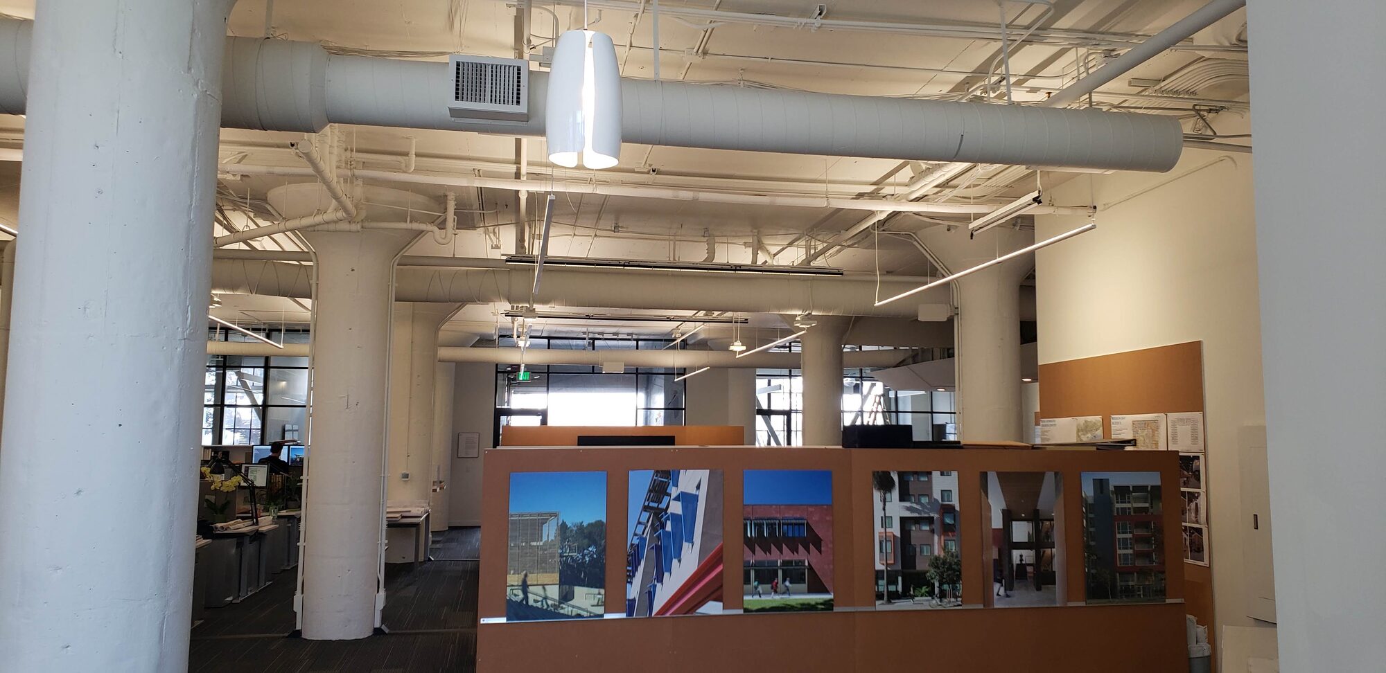 Open office with exposed ductwork and mechanical distribution
